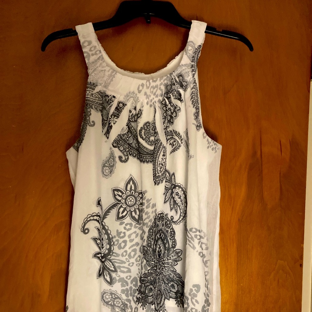 White sleeveless blouse with gray paisley print